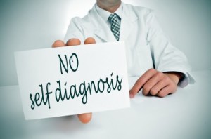Doctor in a white lab coat with a "no self diagnosis" sign.