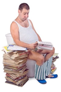 Frustrated, constipated, fat man on the toilet with a big pile of magazines.