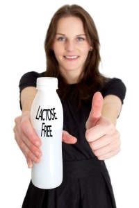 Woman Holding A Bottle Of Lactose Free Milk And Smiling And Doing A Thumb Up