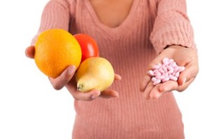 A woman holding fruits and diarrhea pills.