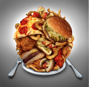 Plate piled high with pizza and fried fatty foods.